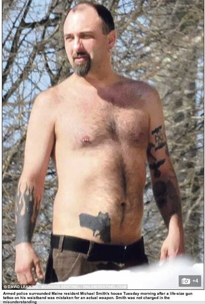 Man with gun tattoo.jpg