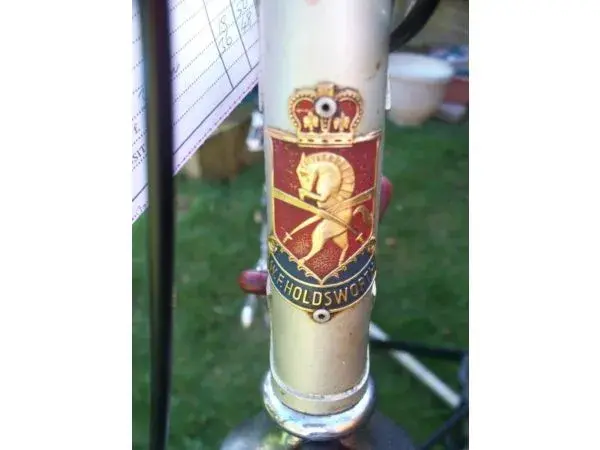 HOLDS HEADBADGE.webp