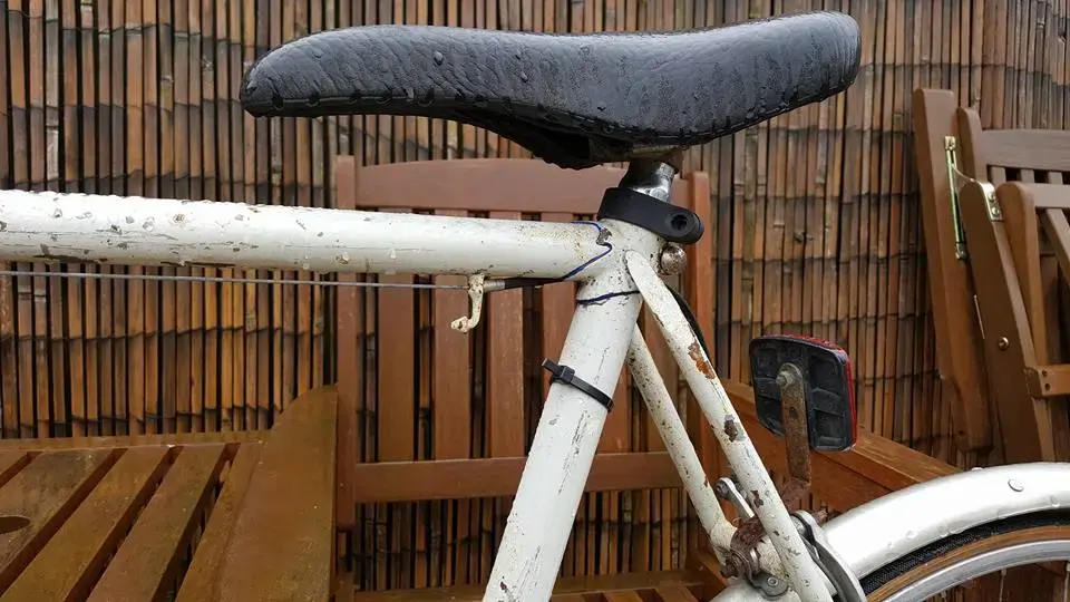 white racing bike seat post.webp