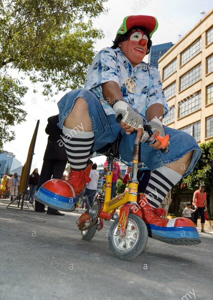 clown-riding-a-miniature-bike-during-a-clown-parade-in-mexico-city-BNHKPY.jpg
