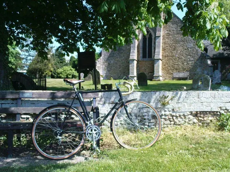 an old bike and an older church.webp