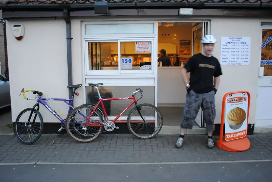out of focus man goes for chips & fish.webp