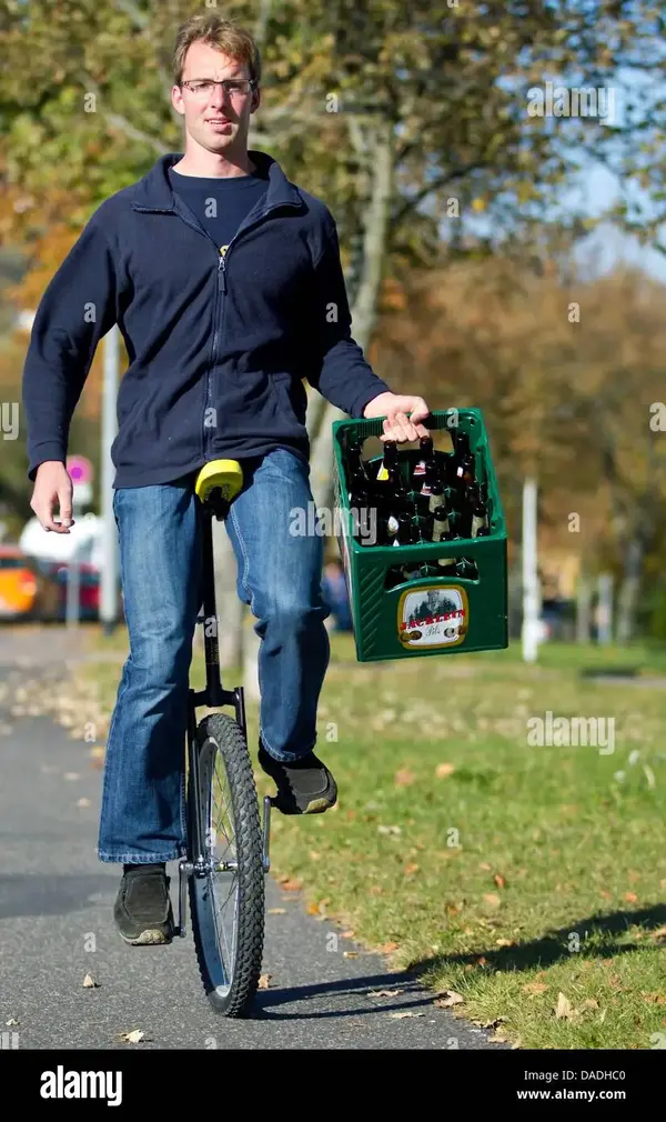 martin-eisenreich-carries-a-beer-crate-while-riding-his-unicycle-throughilmenau-DADHC0.webp